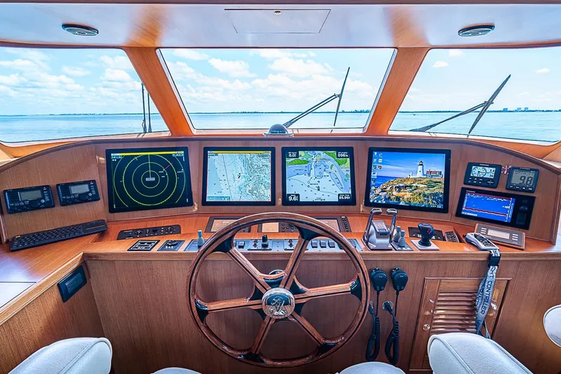 Slide: The Image of Cockpit of 2014 Marlow 80 Explorer yacht with navigation screens and wooden steering wheel. - 5