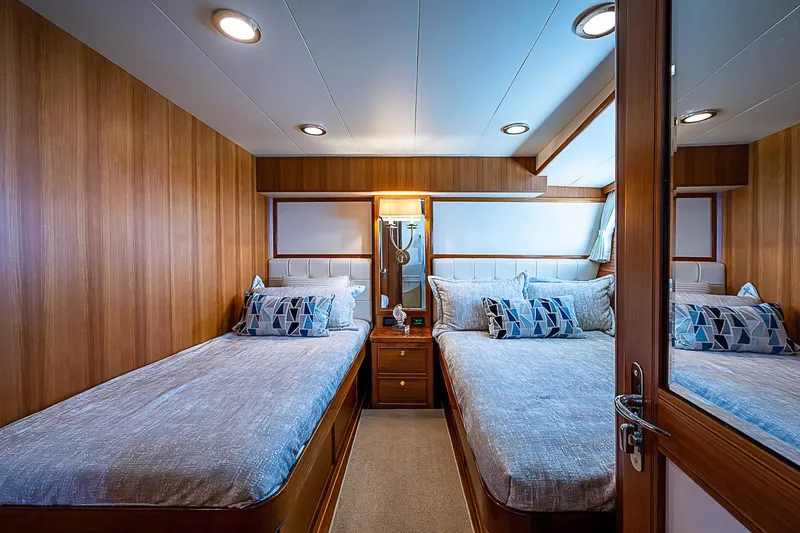 Slide: The Image of Luxurious cabin interior of 2014 Marlow 80 Explorer yacht with twin beds and elegant wood paneling. - 53