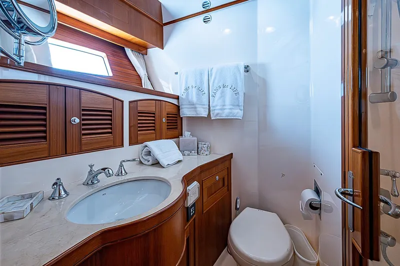 Slide: The Image of Luxurious bathroom in 2014 Marlow 80 Explorer yacht with elegant wood cabinetry. - 55