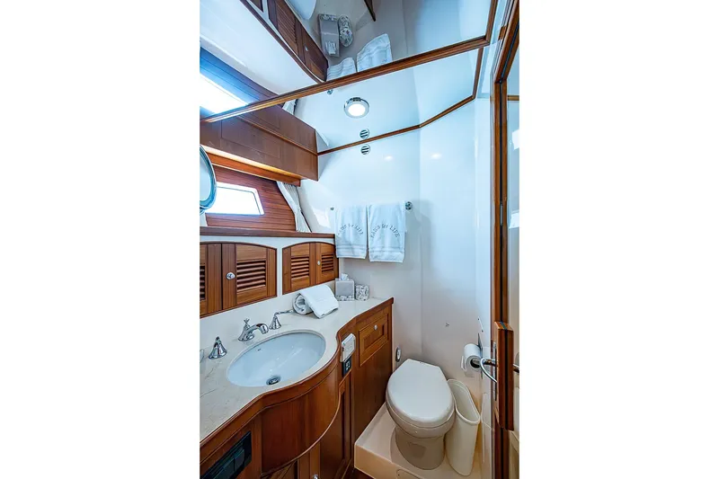Slide: The Image of Luxurious bathroom in 2014 Marlow 80 Explorer yacht with wood accents and modern fixtures. - 56