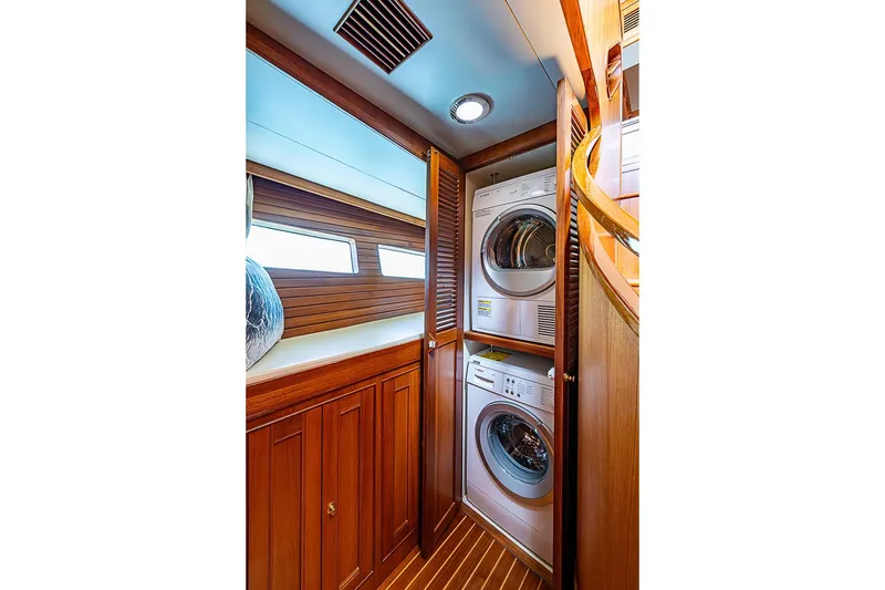 Slide: The Image of Laundry area with stacked washer and dryer in 2014 Marlow 80 Explorer yacht. - 60
