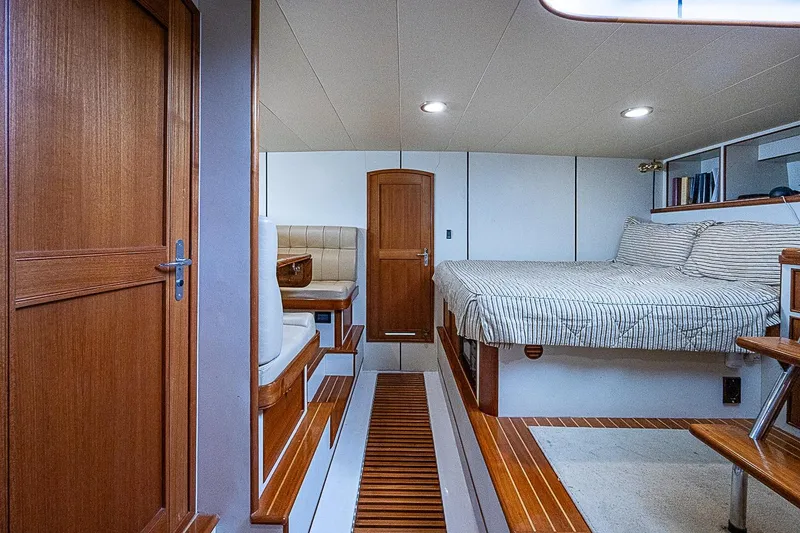 Slide: The Image of Luxurious cabin interior of 2014 Marlow 80 Explorer yacht with wood accents and cozy bedding. - 61