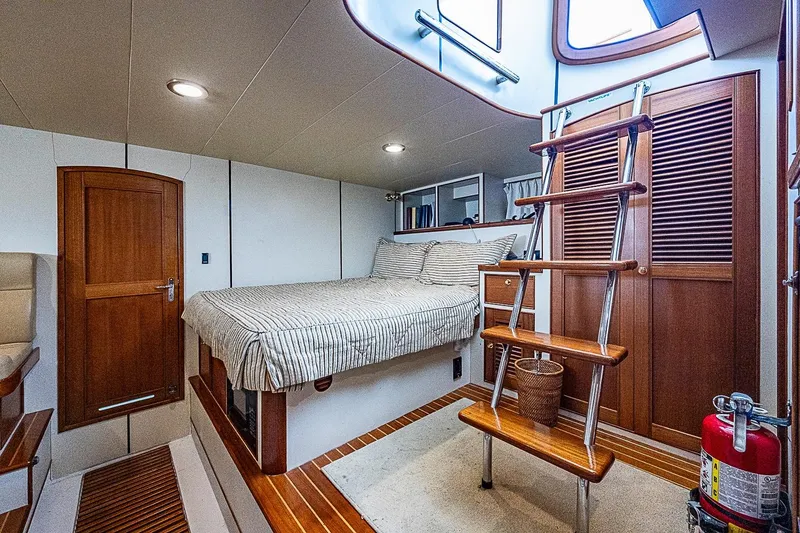Slide: The Image of Luxurious cabin interior of 2014 Marlow 80 Explorer yacht with wooden accents and cozy bed. - 62
