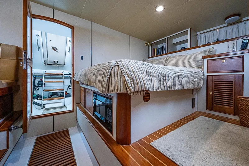 Slide: The Image of Luxurious cabin interior of 2014 Marlow 80 Explorer yacht with cozy bed and wooden accents. - 64