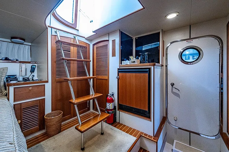 Slide: The Image of Interior of 2014 Marlow 80 Explorer yacht with wooden stairs and nautical decor. - 65