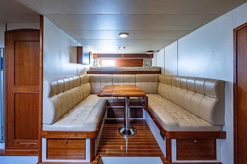 Slide: The Image of Luxurious interior of 2014 Marlow 80 Explorer yacht with elegant seating and wooden table. - 66