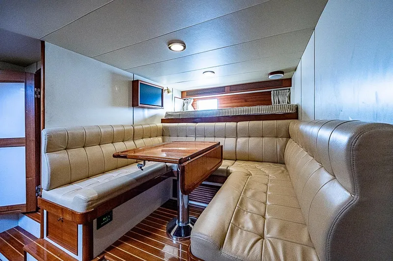 Slide: The Image of Luxurious interior of 2014 Marlow 80 Explorer yacht with plush seating and wooden table. - 67