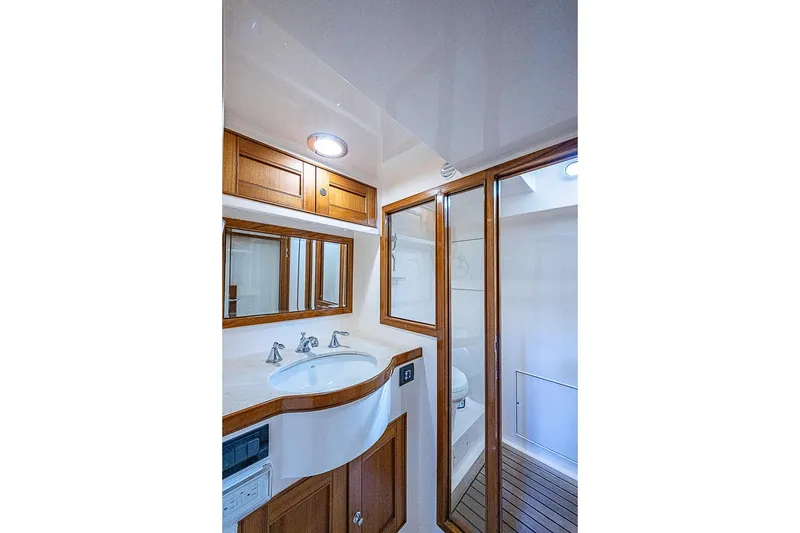 Slide: The Image of Luxurious bathroom in 2014 Marlow 80 Explorer yacht with wooden accents and modern fixtures. - 69