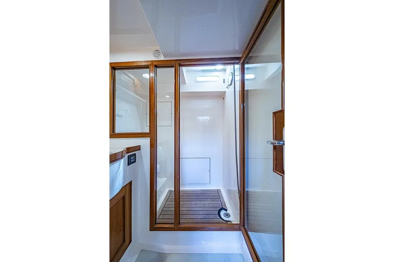 Slide: The Image of Luxurious shower area in 2014 Marlow 80 Explorer yacht with wooden accents. - 70