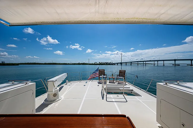 Slide: The Image of Luxurious 2014 Marlow 80 Explorer yacht deck with ocean view and bridge in background. - 75