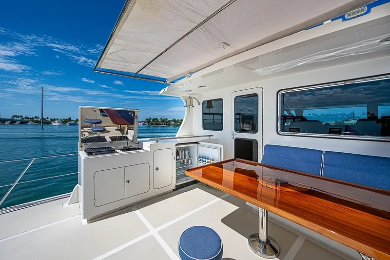 Slide: The Image of Outdoor seating and grill area on 2014 Marlow 80 Explorer yacht, with ocean view. - 76