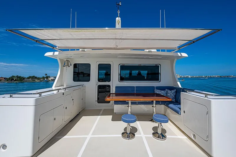 Slide: The Image of Luxury deck of 2014 Marlow 80 Explorer yacht with seating and table. - 79
