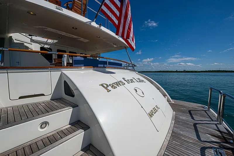 Slide: The Image of Luxury yacht Marlow 80 Explorer 2014, docked with American flag, sunny day. - 83