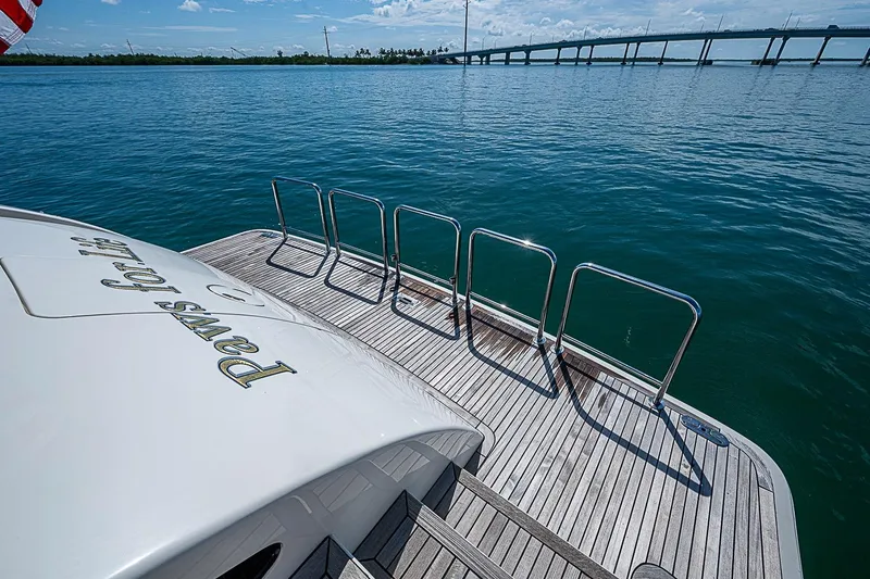 Slide: The Image of Stern view of 2014 Marlow 80 Explorer yacht with wooden deck and ocean backdrop. - 84