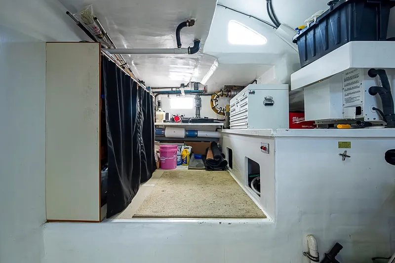 Slide: The Image of Engine room of 2014 Marlow 80 Explorer yacht with tools and storage. - 86