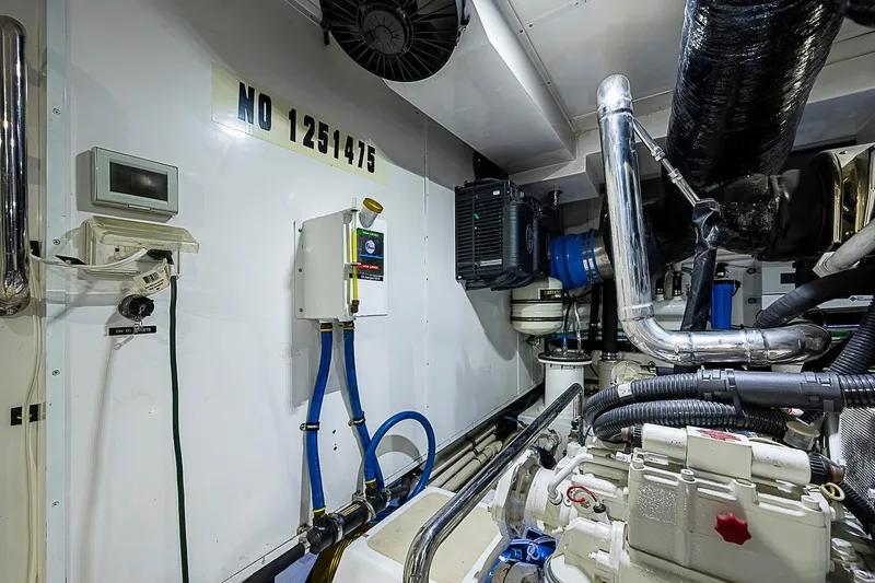 Slide: The Image of Engine room of 2014 Marlow 80 Explorer yacht with equipment and piping. - 98