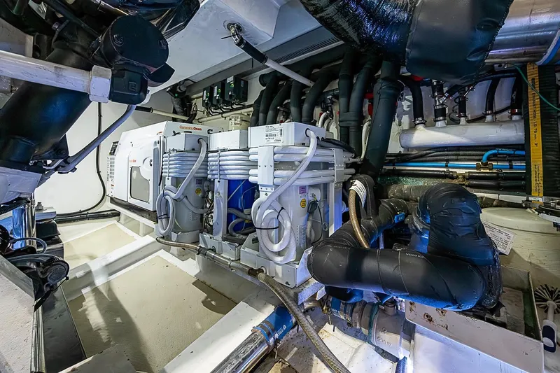 Slide: The Image of Engine room of 2014 Marlow 80 Explorer yacht with complex piping and machinery. - 99