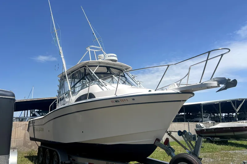 Slide: The Image of 2002 Grady-White Marlin 300 boat on trailer under clear blue sky. - 1