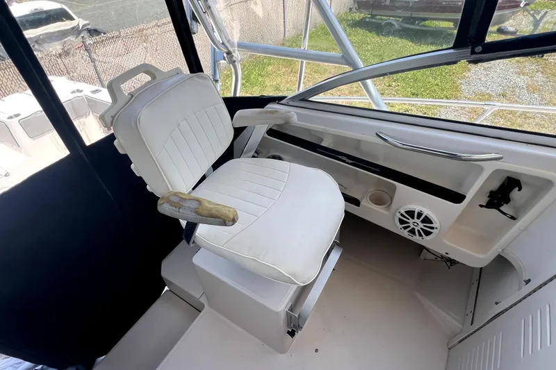 Slide: The Image of Captain's seat on 2002 Grady-White Marlin 300 boat, featuring helm controls and speaker. - 12