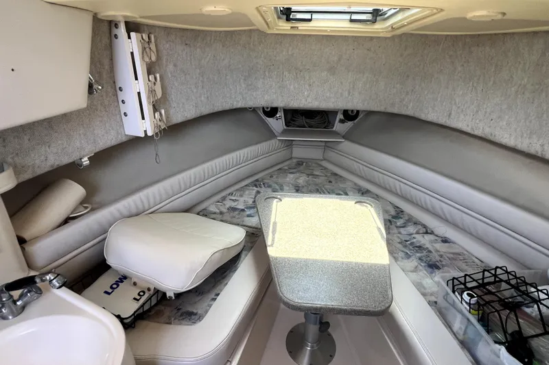 Slide: The Image of Interior cabin of 2002 Grady-White Marlin 300 boat with seating and table. - 16