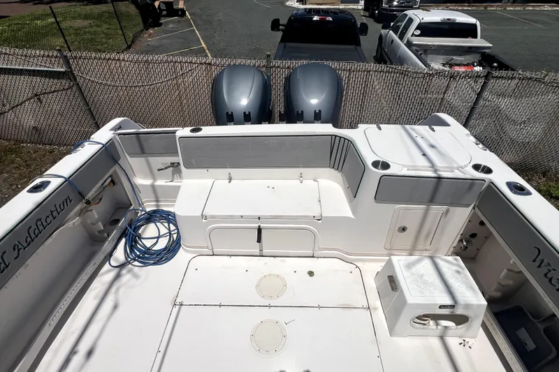 Slide: The Image of 2002 Grady-White Marlin 300 boat deck with twin engines and fishing gear. - 2