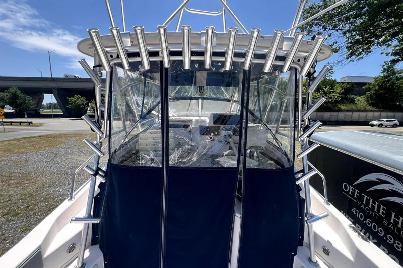 Slide: The Image of 2002 Grady-White Marlin 300 boat with rod holders and clear cockpit enclosure. - 3