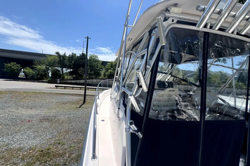 Slide: The Image of 2002 Grady-White Marlin 300 boat parked outdoors under clear blue sky. - 4