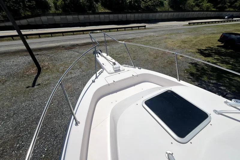 Slide: The Image of 2002 Grady-White Marlin 300 boat deck with railing, parked near a road. - 5