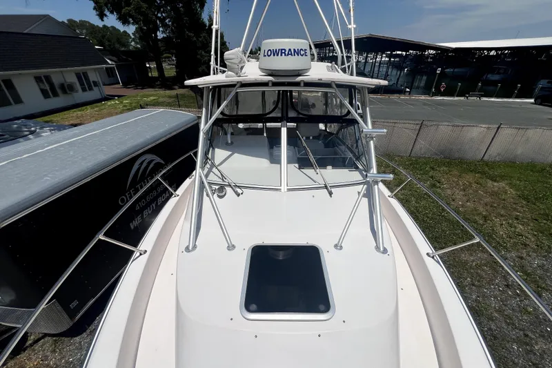 Slide: The Image of 2002 Grady-White Marlin 300 boat with Lowrance radar, docked near marina. - 9