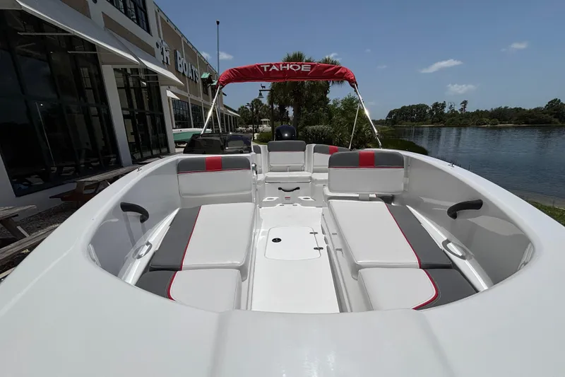 Slide: The Image of 2026 Tahoe T16 boat with spacious seating, docked near a scenic waterfront. - 63
