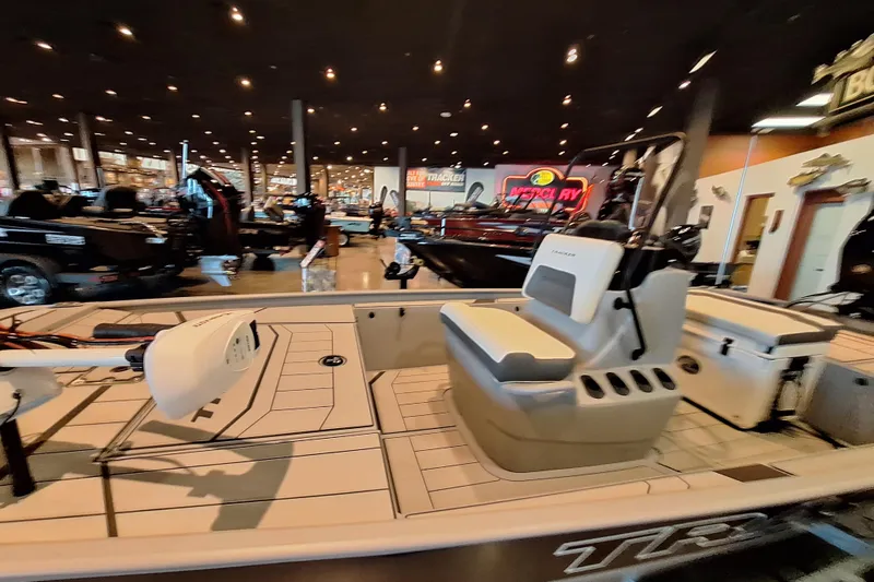 Slide: The Image of 2026 Tracker Bass Tracker Classic CC boat displayed in a showroom with modern interior design. - 3