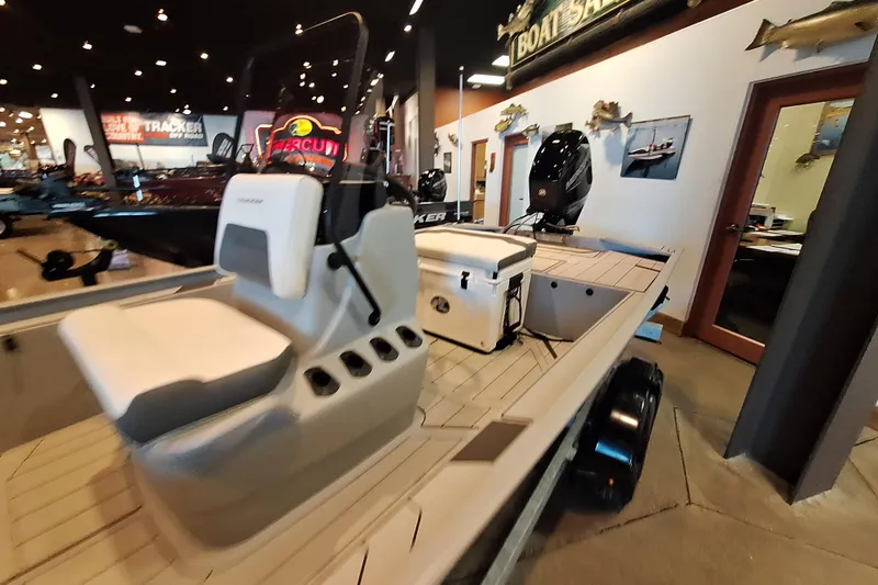 Slide: The Image of 2026 Tracker Bass Tracker Classic CC boat displayed in showroom with modern interior design. - 5
