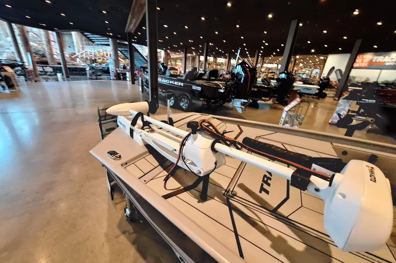 Slide: The Image of 2026 Tracker Bass Tracker Classic CC boat displayed in a showroom with modern lighting. - 4