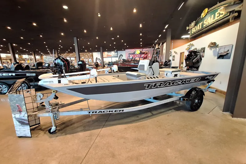 The Image of 2026 Tracker Bass Tracker Classic CC boat displayed in showroom with trailer. - 0