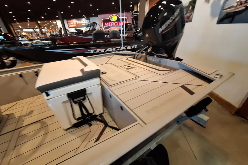 Slide: The Image of 2026 Tracker Bass Tracker Classic CC boat displayed indoors with Mercury engine. - 7