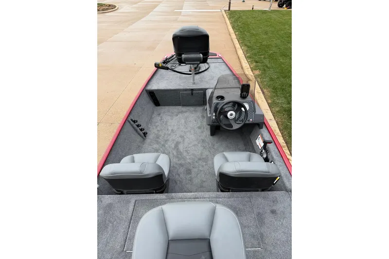 Slide: The Image of 2026 Tracker Bass Tracker Classic XL boat interior with steering wheel and seating. - 3