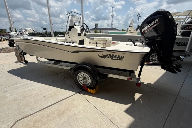 The Image of 2026 Mako Pro Skiff 15 CC boat on trailer, featuring Mercury outboard motor. - 0