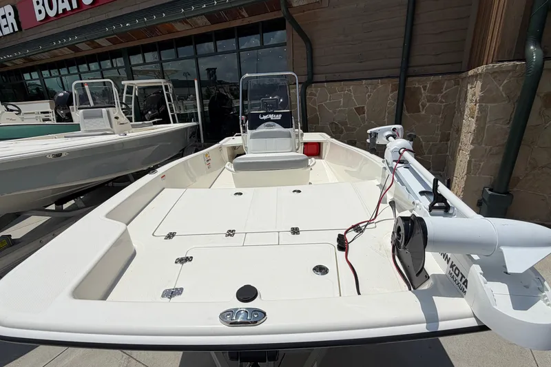 Slide: The Image of 2026 Mako Pro Skiff 15 CC boat displayed outdoors at a dealership. - 7