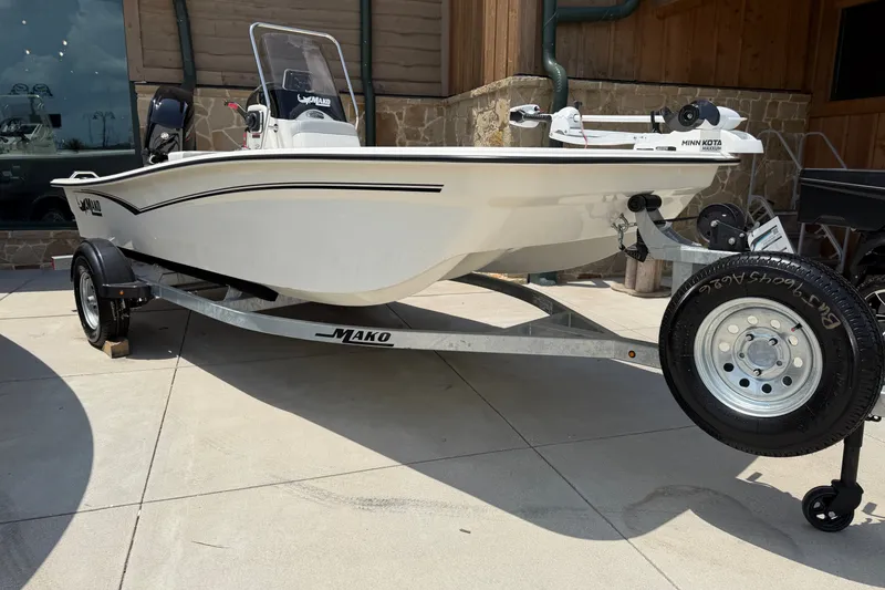 Slide: The Image of 2026 Mako Pro Skiff 15 CC boat on trailer, displayed outdoors. - 3