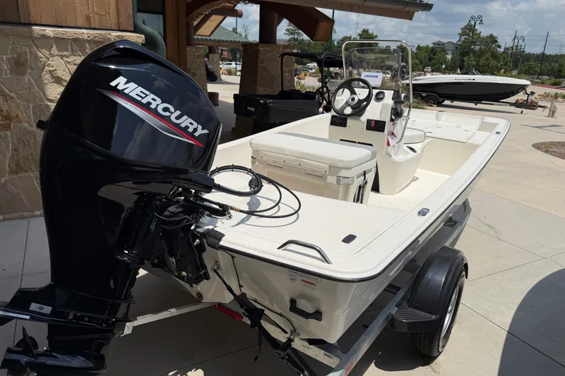 Slide: The Image of 2026 Mako Pro Skiff 15 CC boat with Mercury engine on trailer. - 9