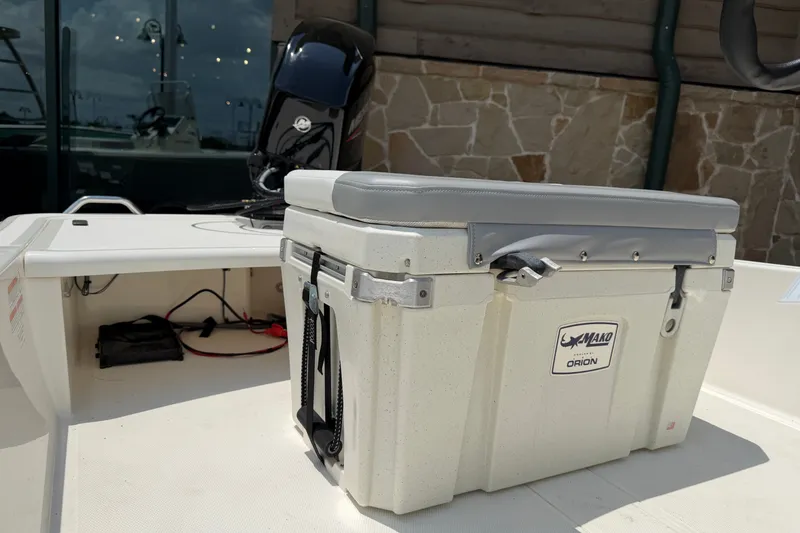 Slide: The Image of 2026 Mako Pro Skiff 15 CC boat with Orion cooler on deck. - 5