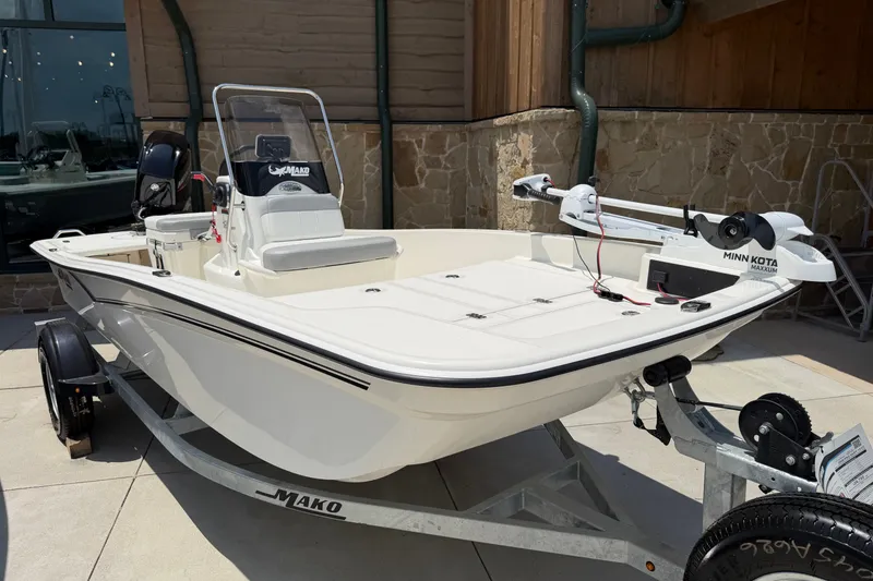 Slide: The Image of 2026 Mako Pro Skiff 15 CC boat on trailer, featuring Minn Kota trolling motor. - 1