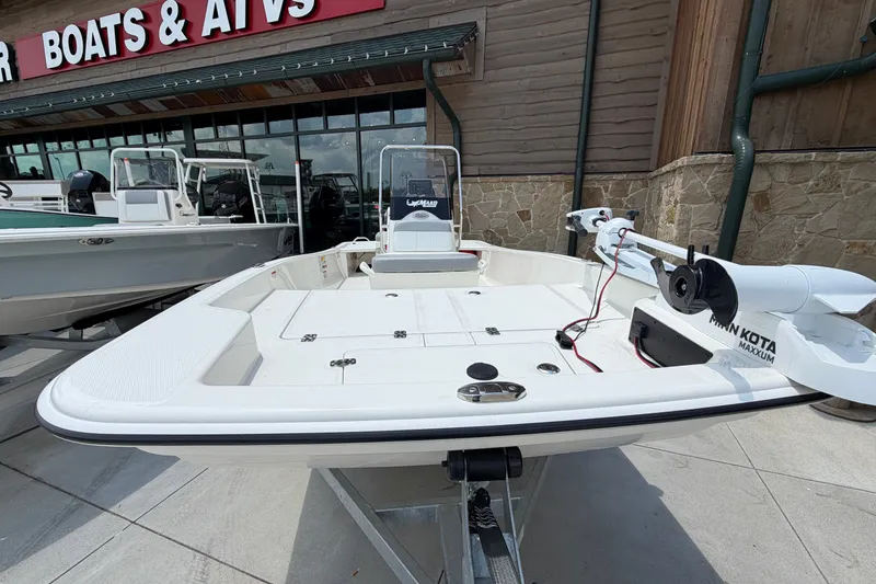 Slide: The Image of 2026 Mako Pro Skiff 15 CC boat displayed outside a dealership. - 4