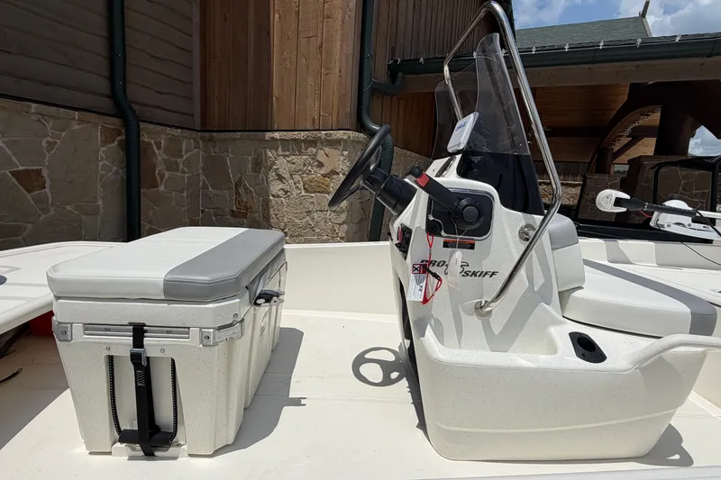 Slide: The Image of 2026 Mako Pro Skiff 15 CC boat interior with console and seating. - 8