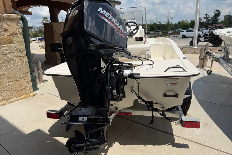 Slide: The Image of 2026 Mako Pro Skiff 15 CC with Mercury outboard motor, parked on a trailer. - 10