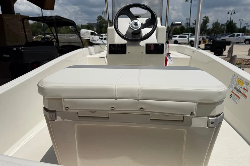 Slide: The Image of 2026 Mako Pro Skiff 15 CC boat interior with steering wheel and seating. - 6