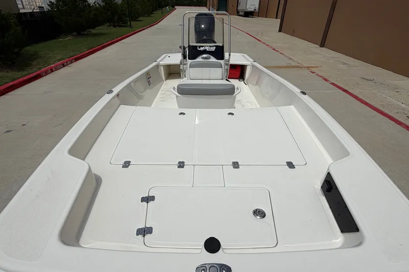 Slide: The Image of 2026 Mako Pro Skiff 15 CC boat, spacious deck, white finish, outdoor setting. - 11