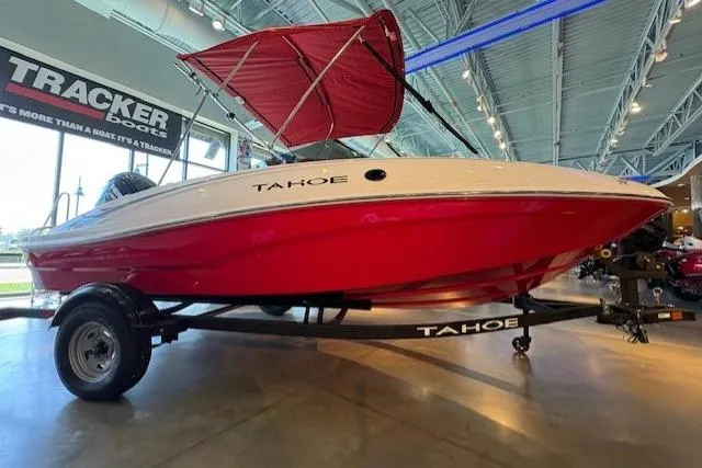 The Image of 2026 Tahoe T16 boat with red hull and canopy on display indoors. - 0