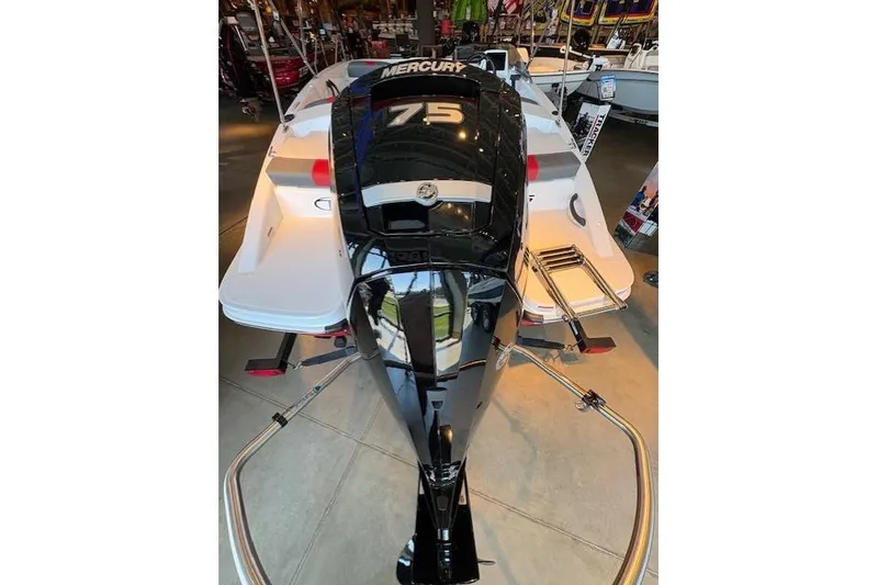 Slide: The Image of 2026 Tahoe T16 boat with Mercury 75 engine displayed in showroom. - 2