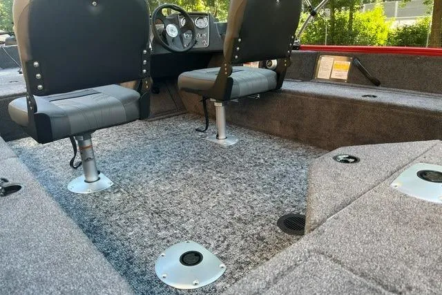 Slide: The Image of 2026 Tracker Pro Guide V-16 SC boat interior with gray carpet and seating. - 13